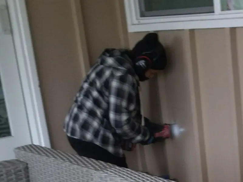 Professional electrician installing an exterior outlet in Beechwood